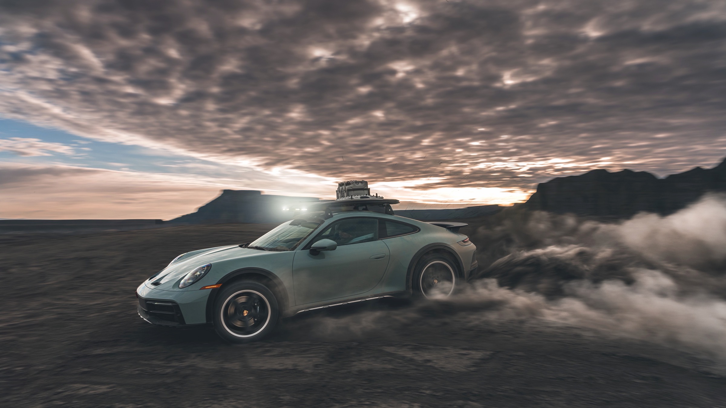 Official Porsche launch photograph of a Shade Green 911 Dakar in Moab. Press vehicle, not Provenance inventory.